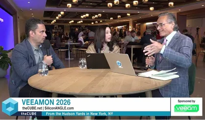 VeeamON 2026 video still of three panelists in conversation at a round table, discussing the Data & AI Trust Maturity Model